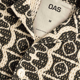 Close up of collar, top button, and fabric texture