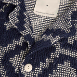 Close up of collar, top button, and fabric texture