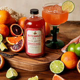 Bottle of Margarita Rosato among display of fruit and prepared drink