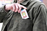 Model demonstrating function of chest pocket with box of candy cigarettes