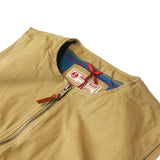 Close up on upper portion of zipped up vest in beige