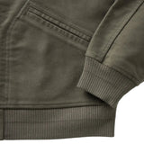 Close up of bottom hem, front pocket, and sleeve opening