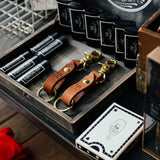 Two leather keychains next to lip balm and a deck of playing cards