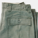 close up of back pocket on olive fatigue pants on white background