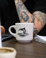 FSC fish diner Mug on counter in front of person
