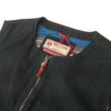 Close up on upper portion of zipped up vest in black