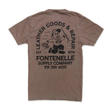 Brown t-shirt with black graphic and text on a white background