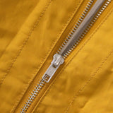 Close up of zipper on tote bag in yellow ochre