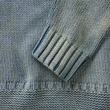 Close up of sleeve opening, bottom hem, and knit fabric