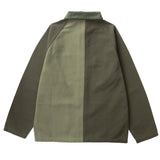 Back of canvas chore-style jacket in color blocked green, one half being lighter and the other darker. 