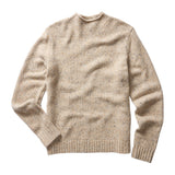 Front of mock neck sweater in a beige knit flecked with little spots of brighter colors. There is ribbing around the sleeve openings, bottom hem, and collar