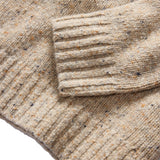 Close up of cuff and bottom hem of beige sweater