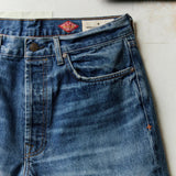 Medium shade, stone-washed indigo denim laid flat
