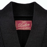 close up of black cardigan neck and tag