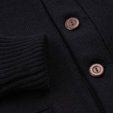 close up of black sweater sleeve and buttons